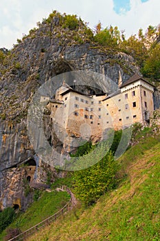 Picturesque view of medieval Predjama castle Slovene. Predjamski grad. Castle at the cave mouth