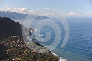 Picturesque view from the mountain on a village at the coastline of Atlantic Ocean on Madeira Island, Portugal