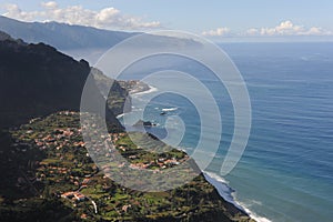 Picturesque view from the mountain on a village at the coastline of Atlantic Ocean on Madeira Island, Portugal