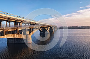 Picturesque view over the Metro Subway Bridge over the Dnipro river in Kyiv, Ukraine. Sunrise at winter morning