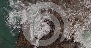 A picturesque view of rocks and stormy waves