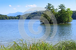 Picturesque view of small lake with wooded islet