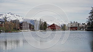 Picturesque view of typical alpine wooden houses on the bank mountain lake. Swiss Alps. Switzerland