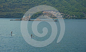 Picturesque view of the water of the Bay of Kotor and the church