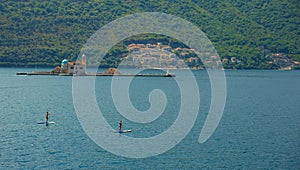 Picturesque view of the water of the Bay of Kotor and the church