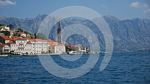 Picturesque view of the water of the Bay of Kotor and the church