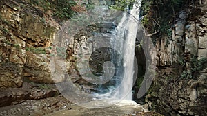 Picturesque view of waterfall in Tbilisi botanical garden filmed at summer day