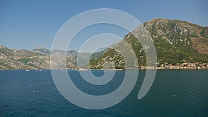 A picturesque view of the waters of the Bay of Kotor and the high mountains rising in the background. One of the most popular