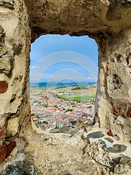 Picturesque view through window of loophole in wall of ancient Rupa fortress in Romania.