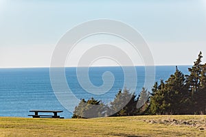 Picturesque view of wooden seat near seaside