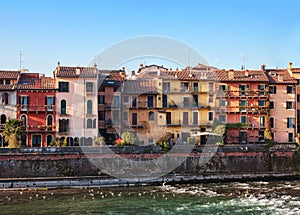 The picturesque views of the houses facades near the Adige river bank, Verona, Italy