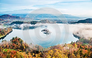 Picturesque views of the island on Lake Bled in the morning fog. Slovenia, Europe. Amazing places. Popular tourist atraction.