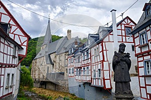 The picturesque village of Monreal with John of Pomuk Statue at the stone bridge in Eifel region, Germany