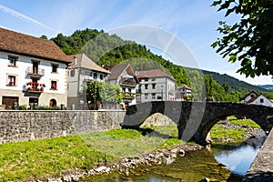 Picturesque village of Ochagavia with three-stored houses and stone bridge photo