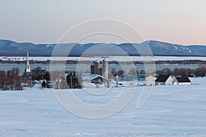 Picturesque village with the St. Lawrence River and the Laurentian mountains in the background