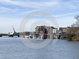 Picturesque vista unfolds over the river, capturing the Prins Clausbrug bridge and the housing development of Stadswerven in