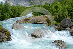 Picturesque water stream with water melted from Jostedalsbreen Glaciern Sogn og Fjordane county, Norway. photo