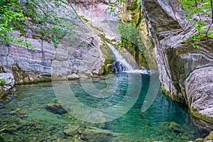 A picturesque waterfall in a cozy mountain lagoon.