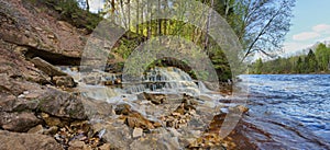 Picturesque waterfall on the river Bank