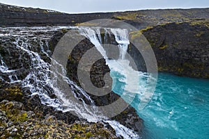 Picturesque waterfall Sigoldufoss autumn view. Season changing in southern Highlands of Iceland