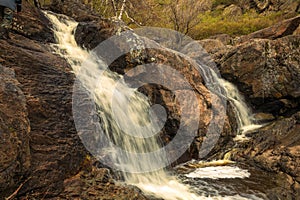 picturesque waterfall on a stream running from the mountains along a ravine