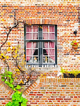 Picturesque window of an old brick house, Bruges, Belgium