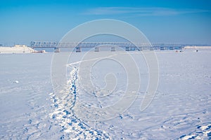 Picturesque winter scenery with road bridge across the Dnieper river near Cherkasy, Ukraine