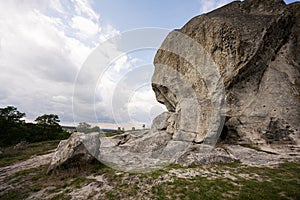 Pidkamin inselberg stone on hill and ancient graveyard. Ukraine