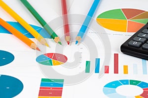 Pie and bar charts with pencils and calculator 2