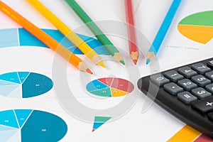 Pie and bar charts with pencils and calculator 3