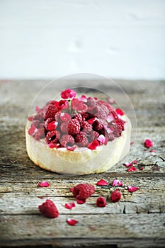 Pie cake with fresh raspberries, rosewater and rose petals photo