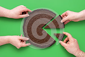 Pie chart concept, people sharing chocolate cake, above view on a green background