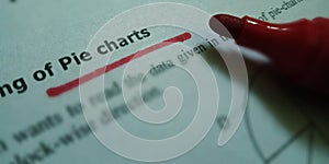 pie charts text underlined with red colour on white paper