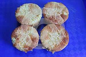 Pie with chesee on a white plate. Sponge cake with black background.