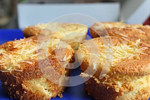 Pie with chesee on a white plate. Sponge cake with black background.