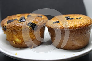 Pie with chocolate chip on a white plate. Sponge cake with black background.