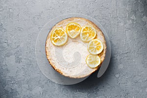Pie from cottage cheese and bananas. Freshly baked cheesecake on rustic background. Lemon decoration. popular sweet
