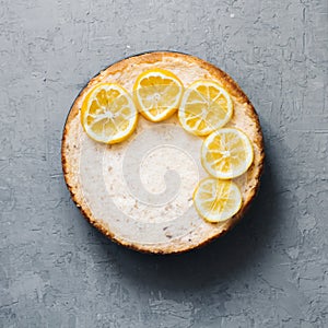 Pie from cottage cheese and bananas. Freshly baked cheesecake on rustic background. Lemon decoration. popular sweet