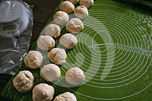 Pie dough balls on a rolling mat.