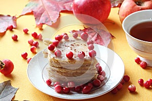 Pie in the form of an autumn leaf, decorated with cranberry berries, close - up-the concept of making delicious pastries on cold