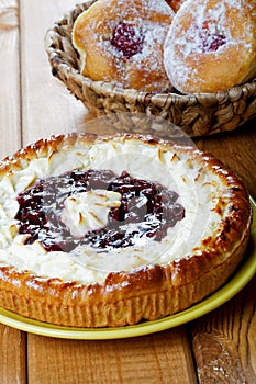 Pie and fruitcakes in plates on a table