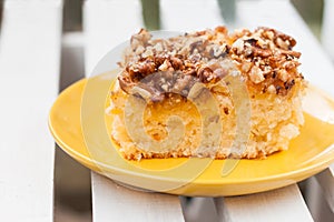 Pie with orange jam and walnuts on a wooden background