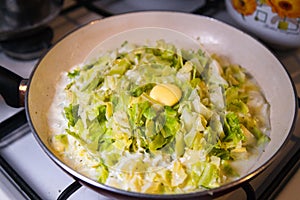 Pie stuffing - braising cabbage in frying pan on a stove. photo