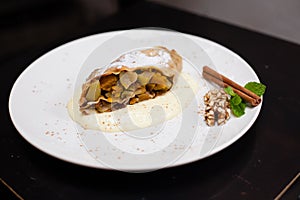 A piece of apetite strudel on a white plate