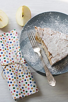 A piece of apple pie lying on the gray plate, apple, fork