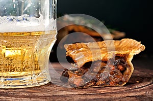 Piece of Australian meat pie with a glass light beer