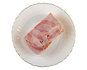 Piece of bacon in plate isolated on white background. Top view