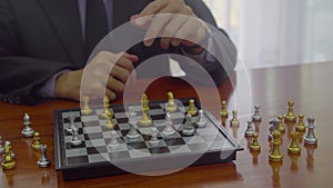 Piece of battle chess game stand behind businessman on chess board background. Financial investment concept for market target stra