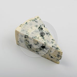 Piece of Blue Cheese on White Background Close Up photo