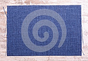 Piece of blue cloth on wooden board background